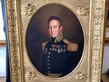 portrait of a man in a military uniform in a gold frame