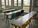 many tables and chairs in this empty classroom