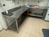 a kitchen with a stainless steel counter and a refrigerator