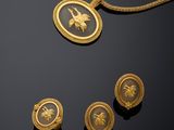 a gold necklace, earrings and ring set with an image of a horse