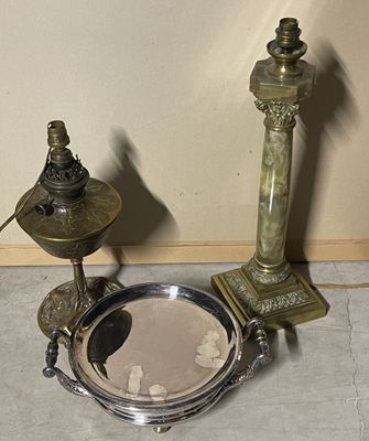 a silver plate with a candle on it next to a lamp