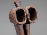 a wooden sculpture of a bird with two beaks on it ' s head