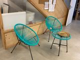 two chairs that are sitting in front of the stairs