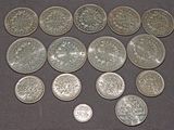 some silver coins sitting on top of a table next to each other
