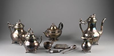 five pieces of silver tea and coffee set on a table