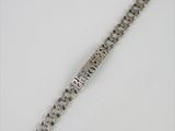an image of a silver bracelet on a white surface
