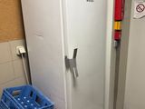 a white refrigerator in the corner of a room next to a wall