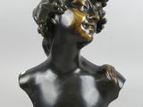 bronze bust of a woman with grapes on her head