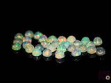white fire oplite beads on a black background