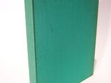 the green book is sitting on a white surface