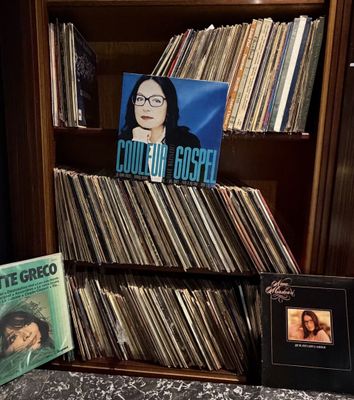 a book shelf with a lot of records on it