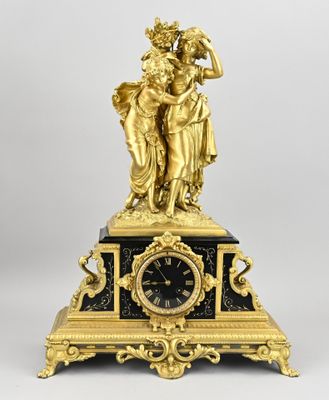 an image of a clock with a statue on top of it