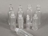 several empty glass bottles sitting on top of a gray surface