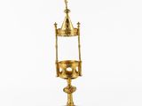 a gold plated chalicet with a cross on top of it