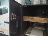 a white van with a door open and a microwave inside of it