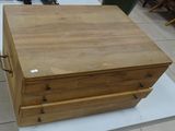 a wooden box with three drawers on a white table