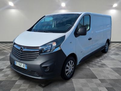 the white van is parked on a checkered floor in a room