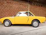 a yellow car that is parked in a garage