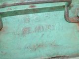 an old green suitcase with a handle on it