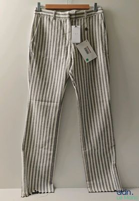 a white and gray striped pants hanging on a hanger
