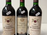 three bottles of wine sitting on top of a table next to each other