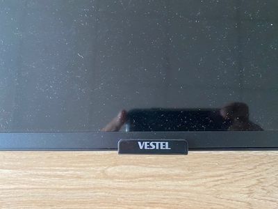 someone is taking a picture of their reflection in the mirror of a tv