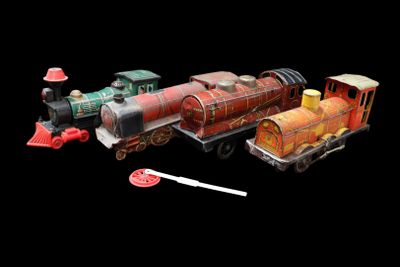 a toy train that is sitting next to other toy trains
