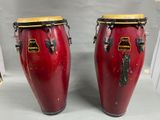 two red congas are sitting on a table with a white background
