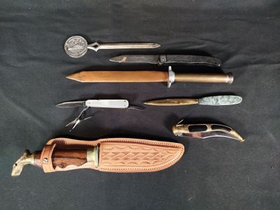 several different types of knives and knives are laid out on a black surface
