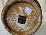 a vase with a tag on it sitting on a table