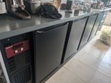 a counter with a bunch of appliances on top of it