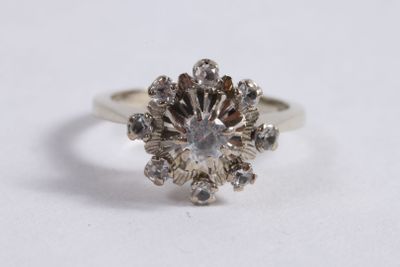 a close up of a diamond ring on a white surface
