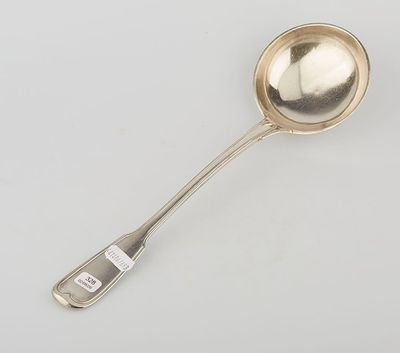 silver plated spoon with handle and spoon rest on a white surface