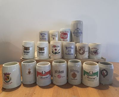 many different types of coffee mugs sitting on a table