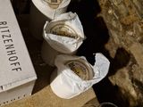 a box of beer sitting on a table next to a glass of wine