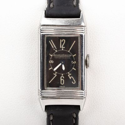 a close up of a watch on a white surface