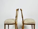 two wooden chairs with upholstered seats on a parqueted wood floor