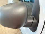 a close up of a car ' s side mirror with a car in the background