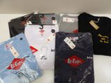 several t - shirts are sitting on a table with a price tag