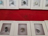 six boxes of different types of rings on a red surface