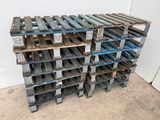 several wooden pallets stacked on top of each other in a room