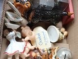 a cardboard box filled with assorted figurines and figurines