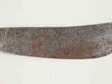 a close up of a knife on a white surface