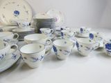 a lot of cups and saucers sitting on a table