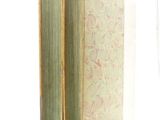 a book with a green cover sitting on a white surface