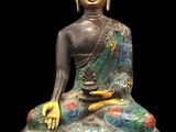statue of a seated buddha on a black background with a black background