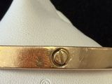 an image of a close up of a gold bracelet on a mannequin