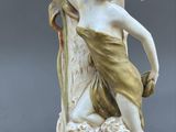 a statue of a woman holding a shell in her hand