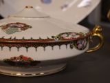a bowl with a lid and a plate on a table