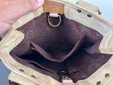 a person holding a purse that has a ring on it